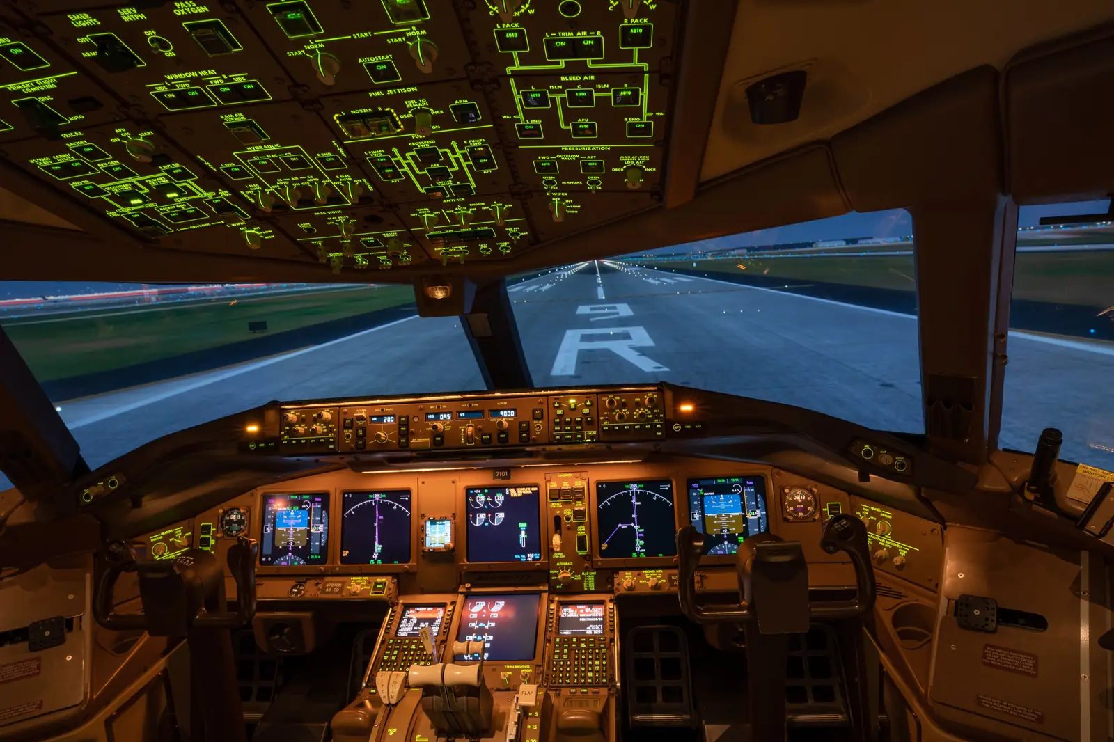 Cockpit lined up on a runway at dusk